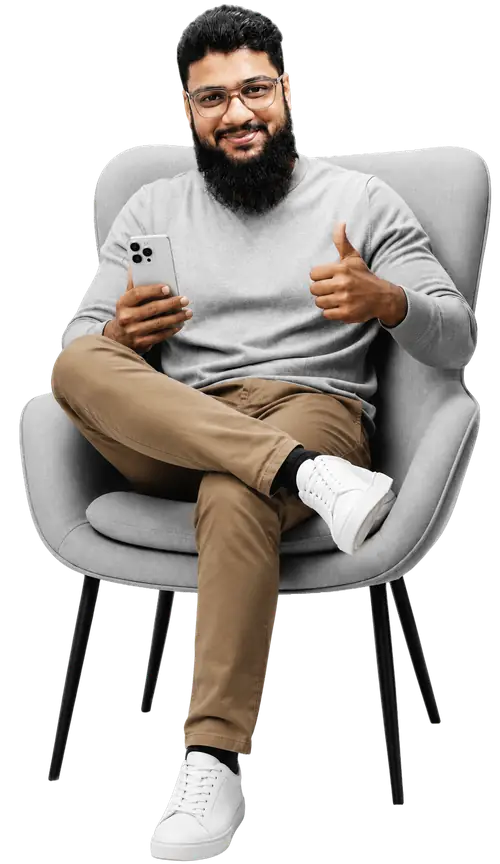 Ali Hossain sitting in a chair with a thumbs up